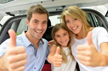 Cheerful family showing thumbs up