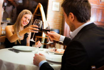 Couple toasting wineglasses in a restaurant